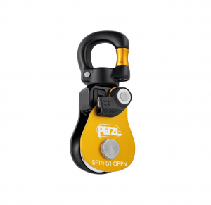 Eine Nahaufnahme der Seilrolle Petzl SPIN S1 OPEN zeigt ihr schwarz-gelbes Design mit einer drehbaren Ösenbefestigung, die sich ideal für technische Seilarbeiten eignet. Der Markenname „Petzl“ ist deutlich auf der gelben Frontplatte zu sehen und unterstreicht den Ruf des Unternehmens für Zuverlässigkeit und Präzision im Design.